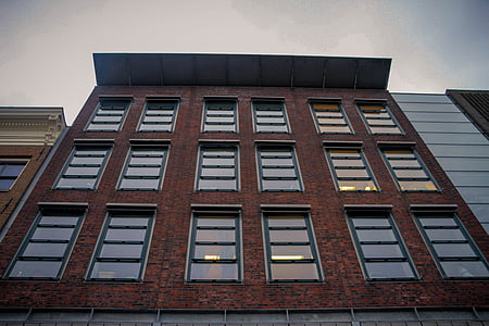 low angle photography of dark-brown concrete building thumbnail