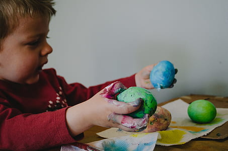 boy holding colored eggs thumbnail