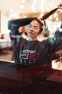 woman wearing black Tommy Hilfiger sweater in room thumbnail
