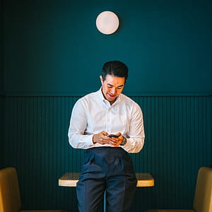 Man Holding Black Smartphone thumbnail