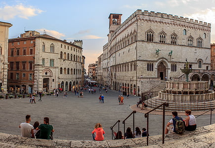 group of people sitting in front of building thumbnail