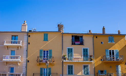 photo of brown concrete buildings under clear blue sky during daytime thumbnail