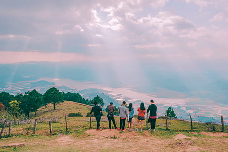 Group Of People Standing On Hill thumbnail