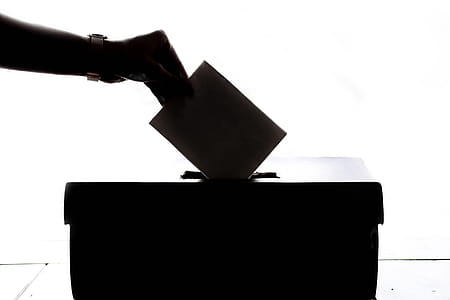 Person Dropping Paper On Box thumbnail