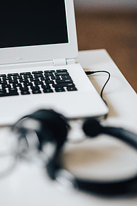 White laptop with smartphone and headphones thumbnail