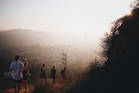 five people walking on road with grasses thumbnail