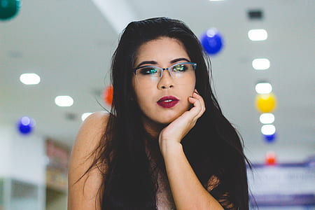 woman wearing eyeglasses near white wall thumbnail