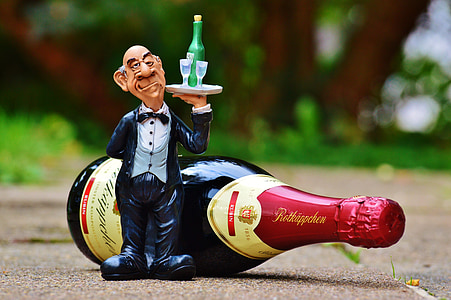 butler figurine beside wine bottle thumbnail