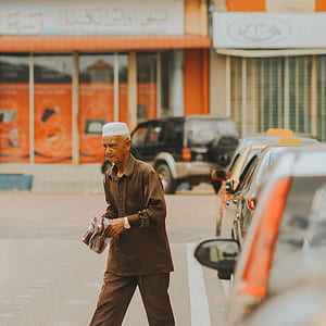 man standing beside car thumbnail