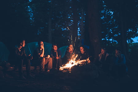people sitting in front of firewood thumbnail