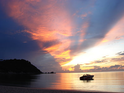 motorboat parked on body of water during sunsaetr thumbnail