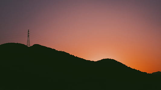 silhouette photography of tower on mountain thumbnail