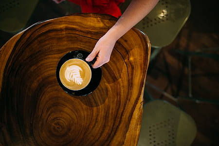 high angle photo of person holding a cup of coffee thumbnail