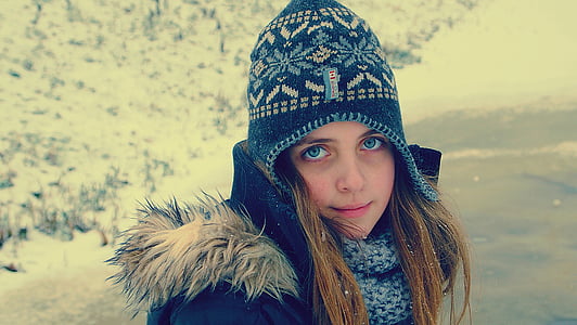 girl wearing blue hat and black coat at daytime thumbnail