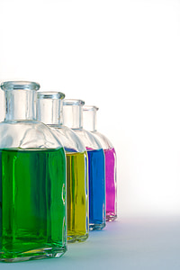 four clear glass flasks with several assorted-color liquids thumbnail