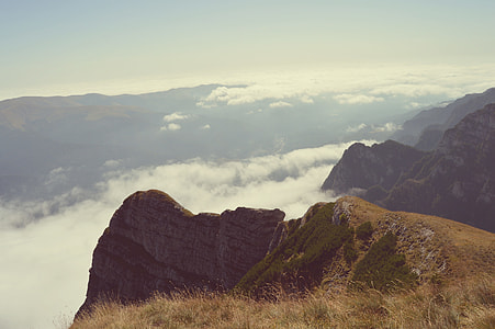 aerial landscape photography of mountains under white clouds thumbnail