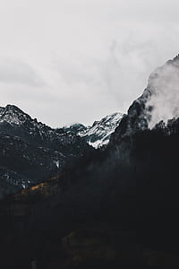 snow covered mountain under cloudy sky during daytime thumbnail