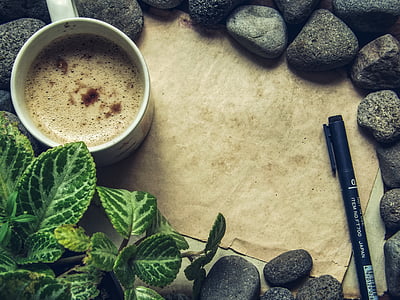 ceramic mug filled with liquid near pen thumbnail