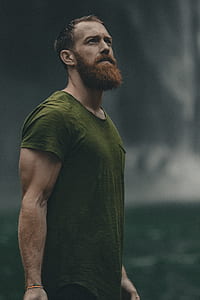 man wearing green crew-neck t-shirt standing on closeup photography thumbnail