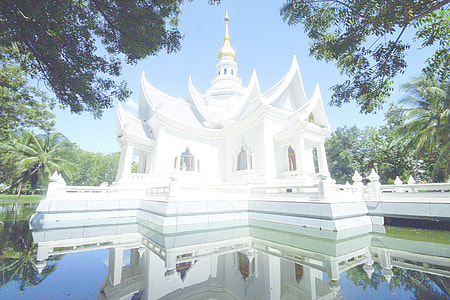 white concrete castle near clear pond at daytime thumbnail