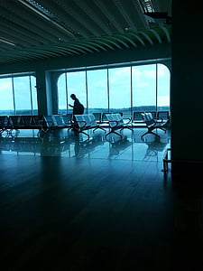 man walking beside curtain wall thumbnail