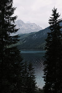calm body of water near mountain thumbnail