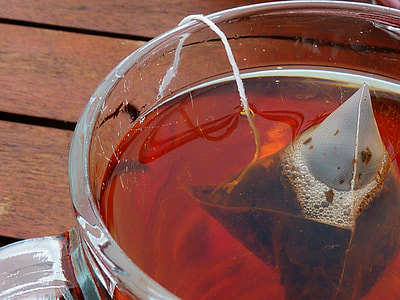 clear glass mug filled with tea thumbnail