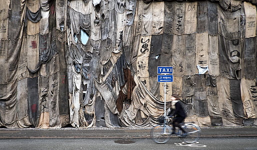 photo of person riding bicycle along street thumbnail