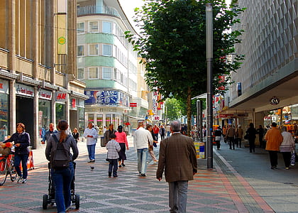 people walking on street between buildings thumbnail