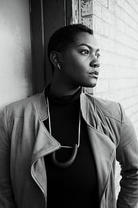 grayscale photography of person wearing gray coat thumbnail