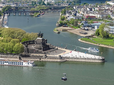 black statue surrounded by trees and river thumbnail