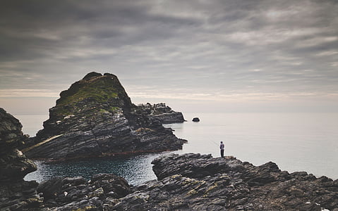 person fishing standing on rock thumbnail