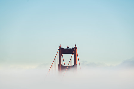 photography of bridge with fog during daytime thumbnail