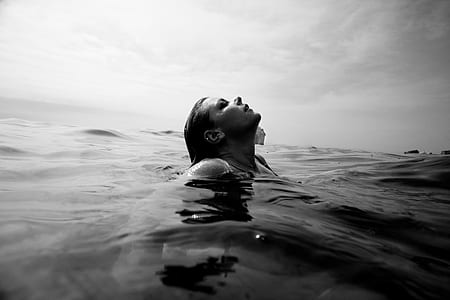 grayscale photography of woman in body of water thumbnail