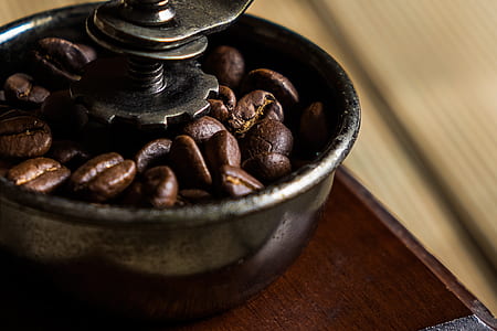 selective focus photography of vintage coffee grinder with coffee beans thumbnail