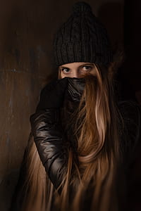 woman covering mouth with black leather jacket thumbnail