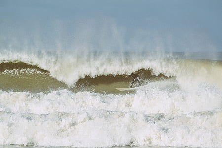 person surfing on sea wave thumbnail