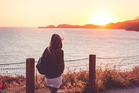 Young Girl on a Walk Near The Shore at Sunset thumbnail