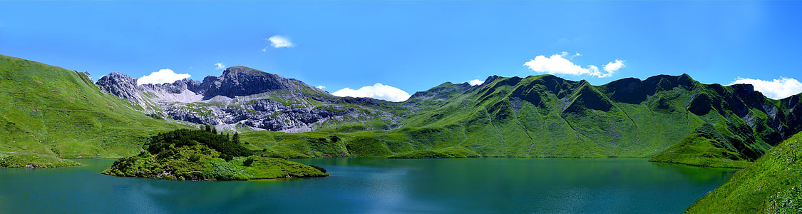 green mountain under body of water thumbnail