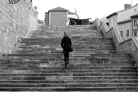 grayscale photography of person on concrete stairs thumbnail