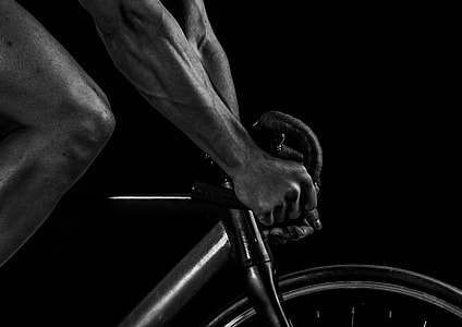 grayscale photo of man riding road bike thumbnail