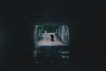 silhouette of person jumping on gray asphalt road during daytime thumbnail