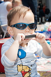 boy playing harmonica thumbnail