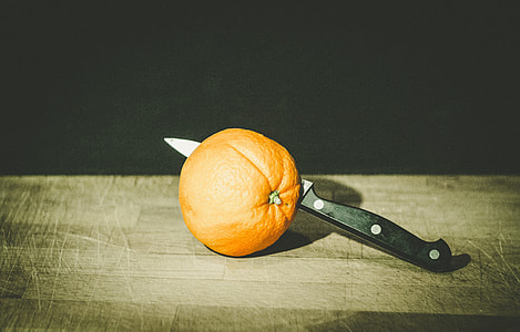 black kitchen knife beside orange thumbnail