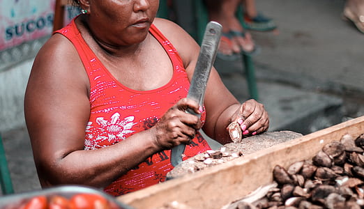 woman sitting chopping nut thumbnail