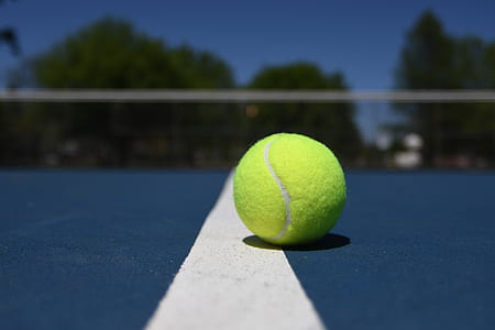 close-up photography of green baseball on blue and white painted floor thumbnail