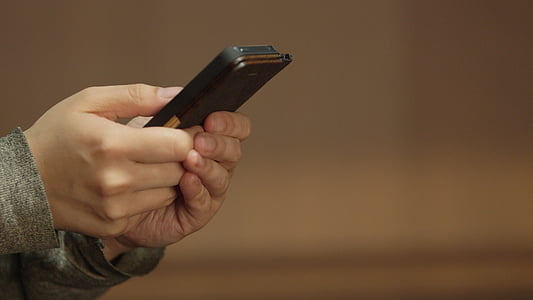 person holding smartphone thumbnail