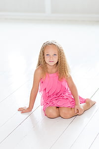 girl wearing pink dress sitting on the floor thumbnail