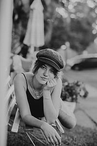 grayscale photo of woman lying on bench thumbnail
