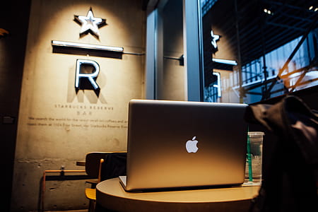 lowlight photography of silver MacBook on top of round side table thumbnail
